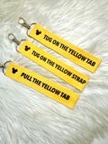 Pull The Yellow Tab Keychain | Yellow Strap Keychain | theme park Keychain
