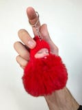 Keychain shaped like a baby sucking a pacifier